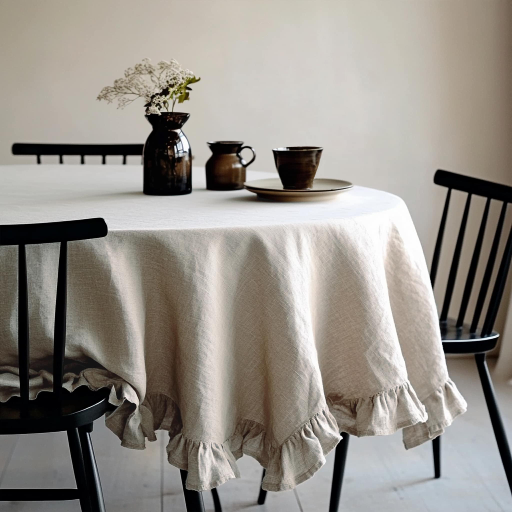 Natural ruffled linen tablecloth draped over a rustic wooden dining table - Linen Times